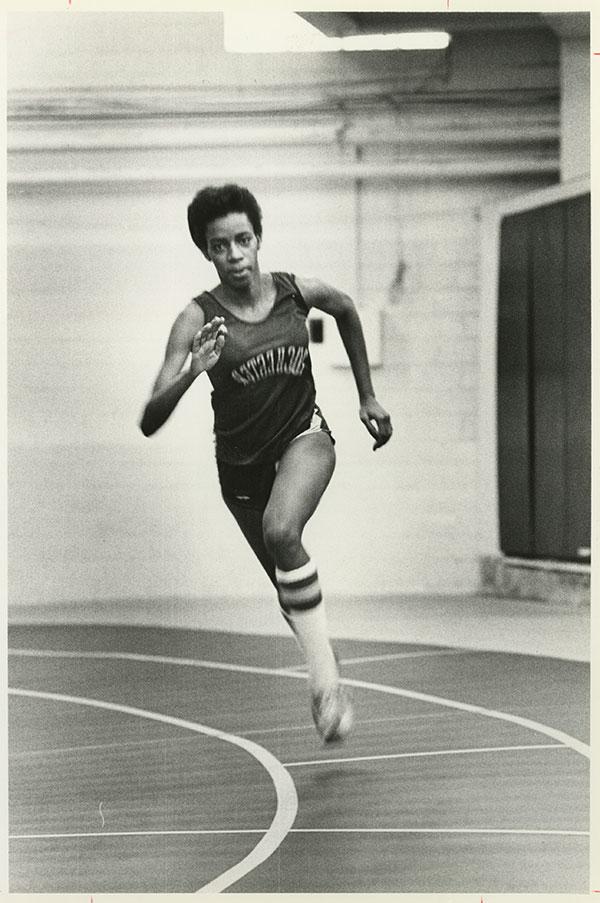 A younger Jackie Blackett ’81 running on a track.