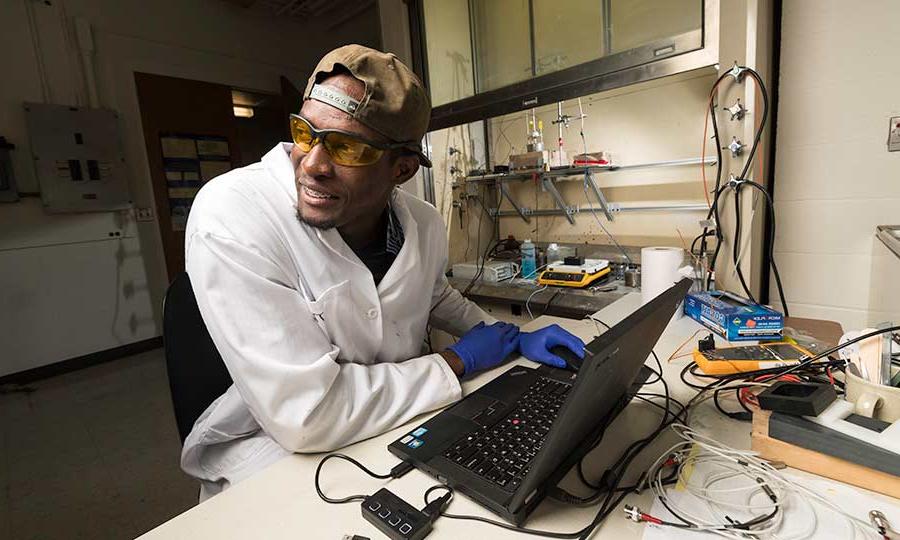 Researcher a laptop in lab at University of Rochester