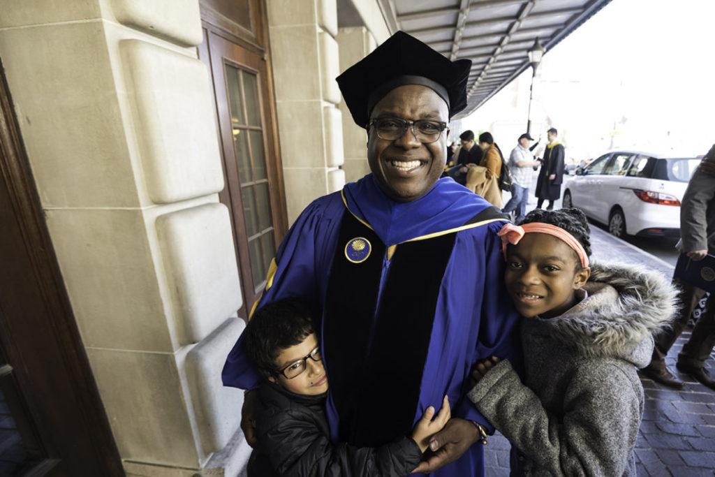 A University of Rochester doctoral graduate with his children
